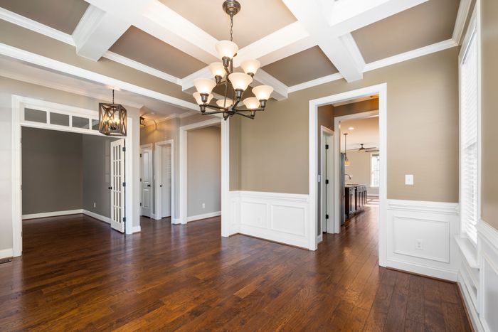 Craftsman style crown molding and wainscoting in a dining room with wood chair rail