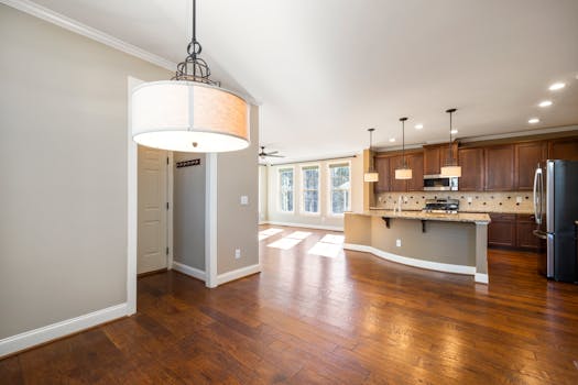 Bright and spacious modern kitchen with hardwood floors and elegant lighting.