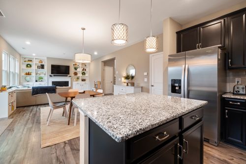 Free Spacious open-concept kitchen with granite countertop and cozy living area. Stock Photo
