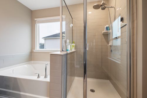 A Contemporary Bathroom with a Bathtub and  Glass Divider