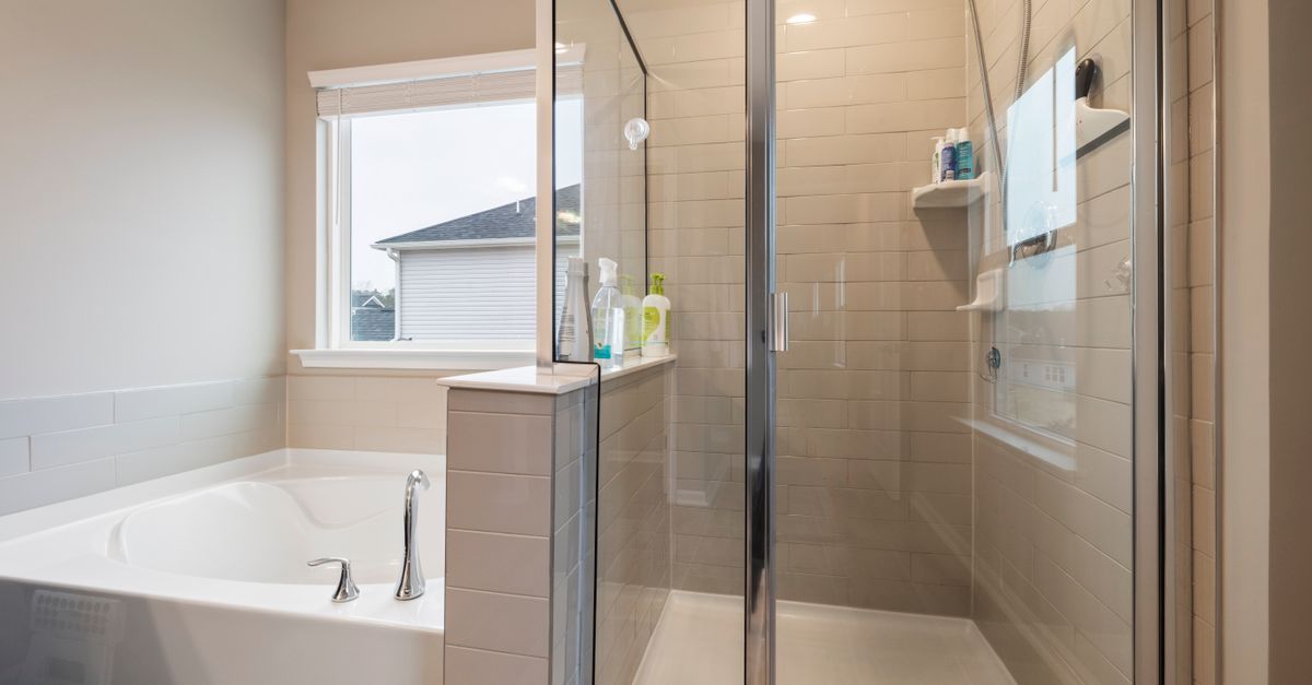 A contemporary bathroom featuring a glass shower and luxurious bathtub for stylish home design.