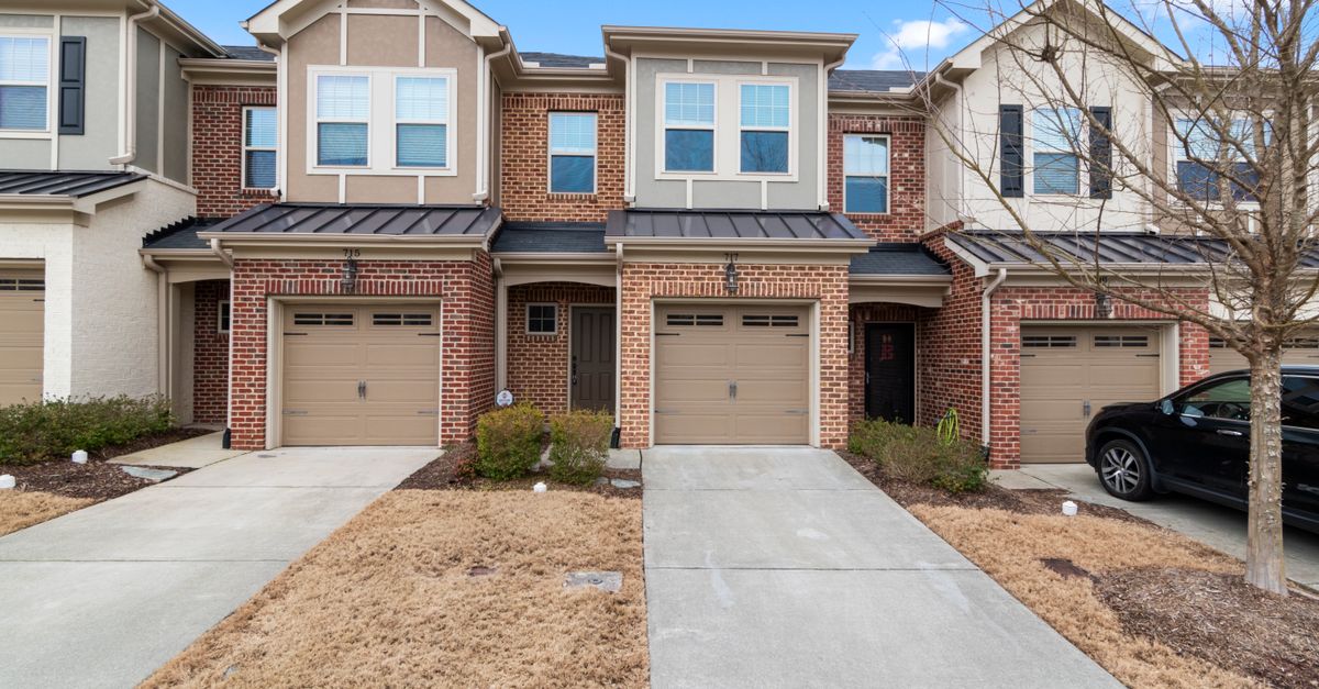 Elegant suburban brick townhouses with driveways in an upscale neighborhood.