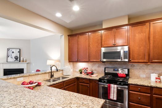 Stylish kitchen with granite countertops, wooden cabinets, and stainless steel appliances.