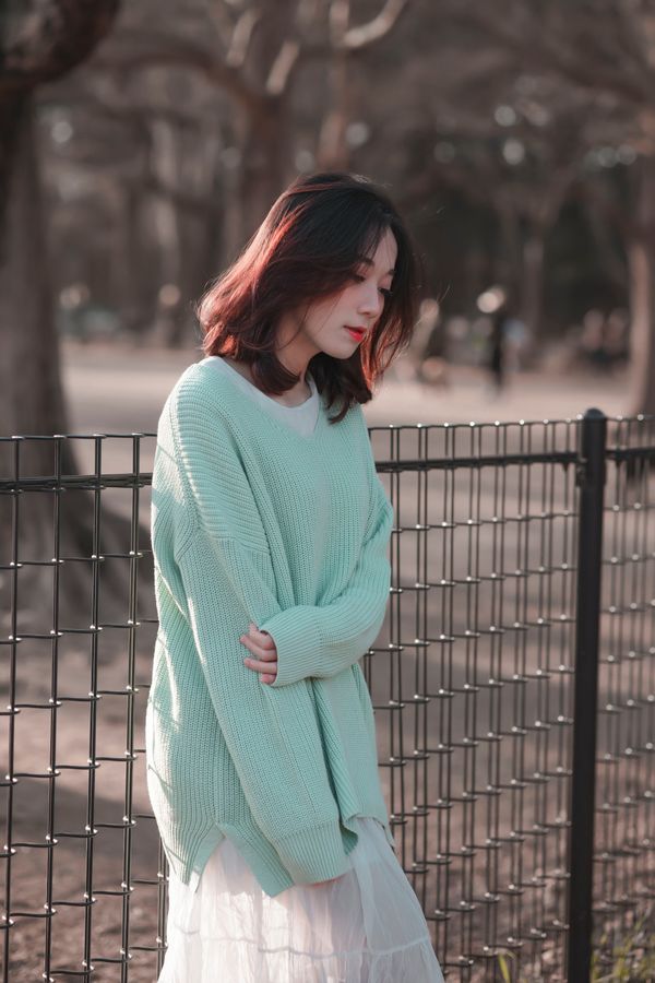 Pistachio ribbed sweater half tucked into relaxed jeans