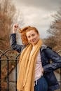 Woman in Black Leather Jacket and Brown Scarf