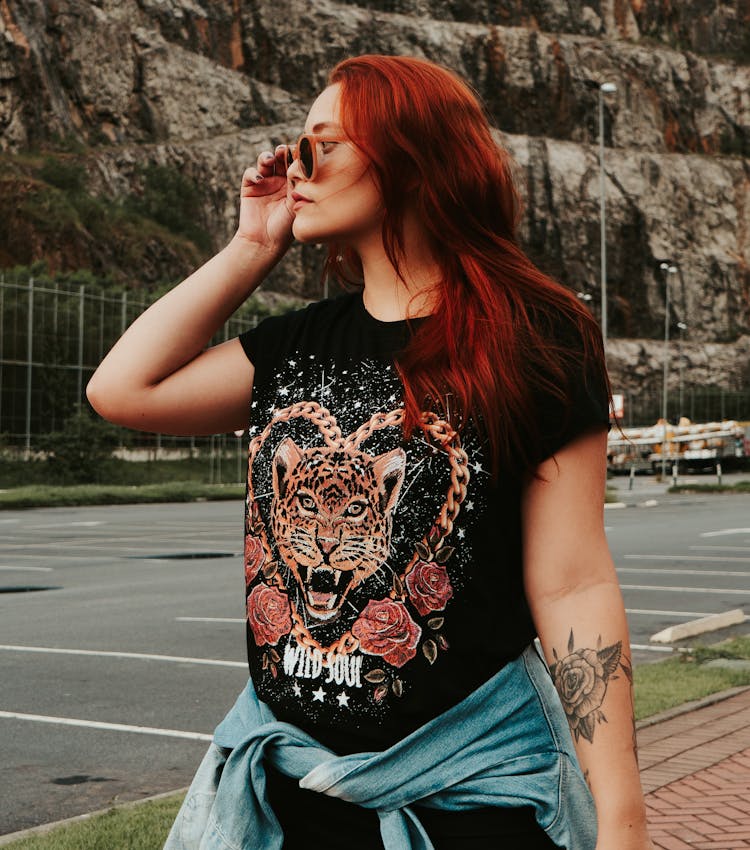 A Woman In Black Shirt With A Cheetah Print Wearing Sunglasses