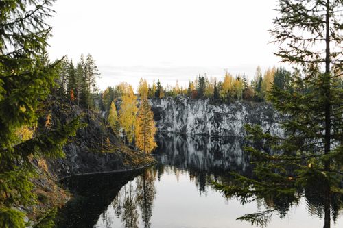 Free Tranquil view of autumnal forest and calm waters in Karelia, Russia Stock Photo