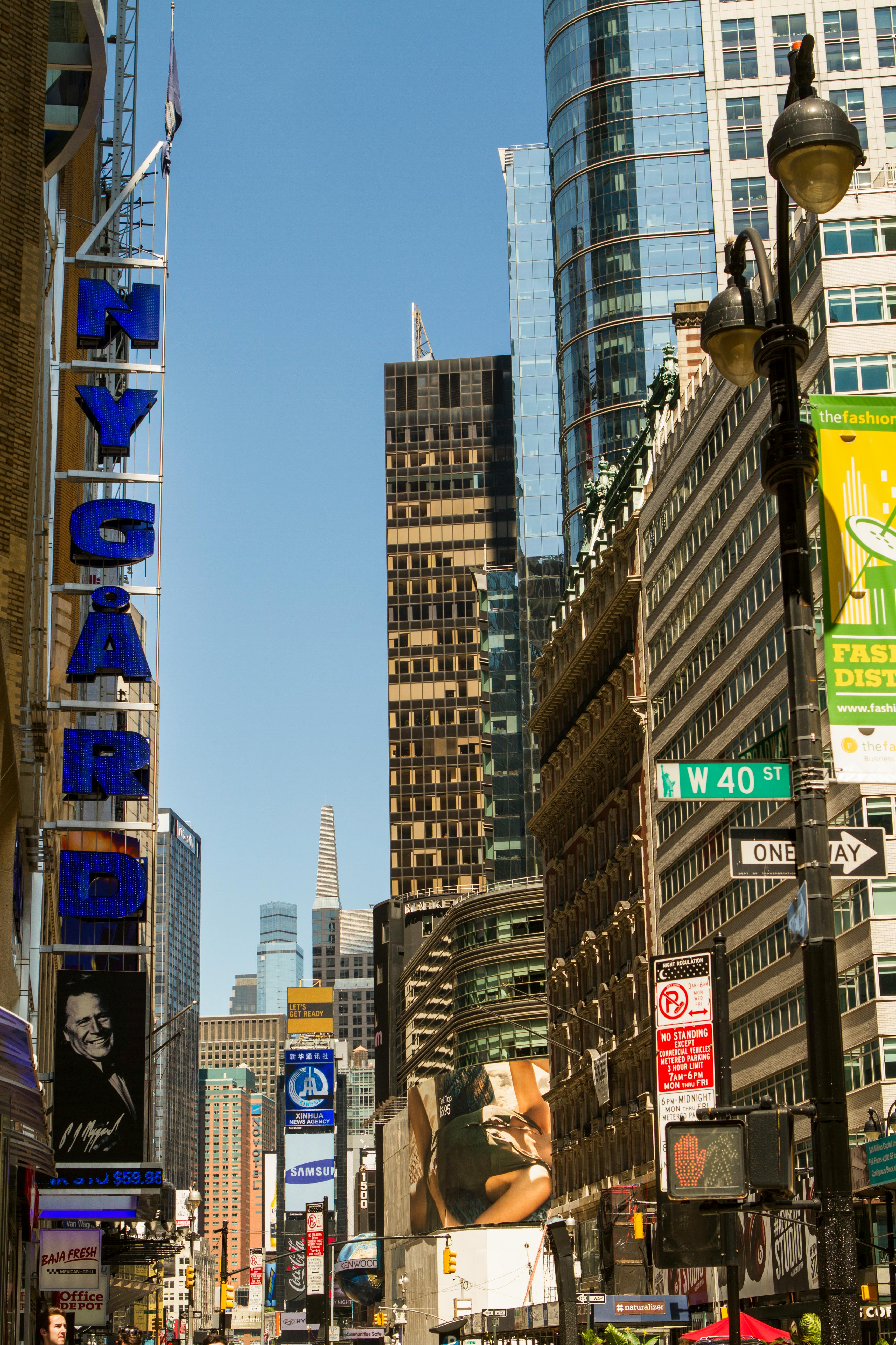 A Blue Signage Near High Rise Buildings · Free Stock Photo