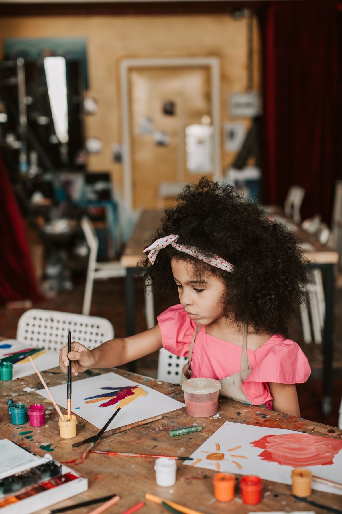 Young girl focusing on her painting in an art workshop