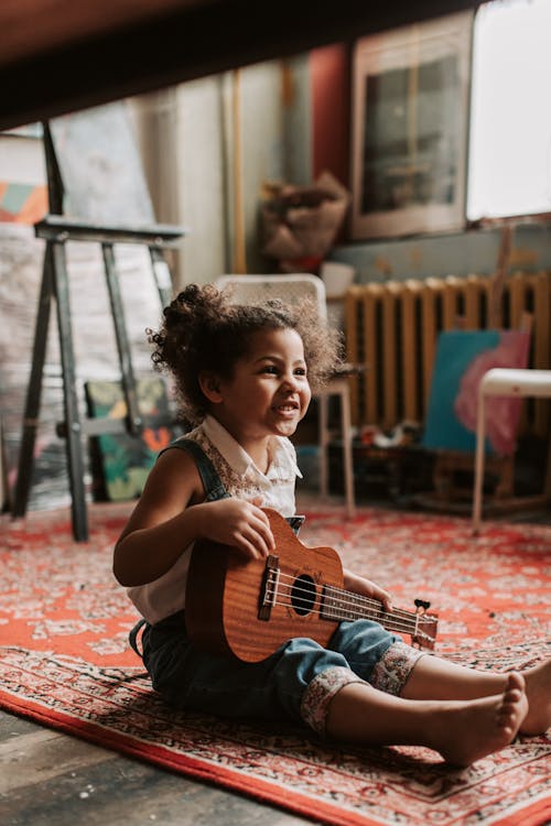 Free Girl Holding a Ukulele Stock Photo