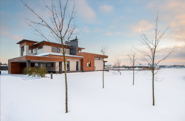 Cottage House Exterior In Winter Day