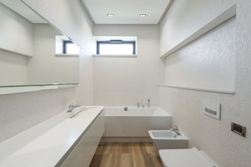 Modern bathroom interior with white walls and furniture