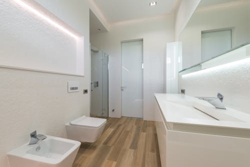 Spacious bathroom interior with white furniture