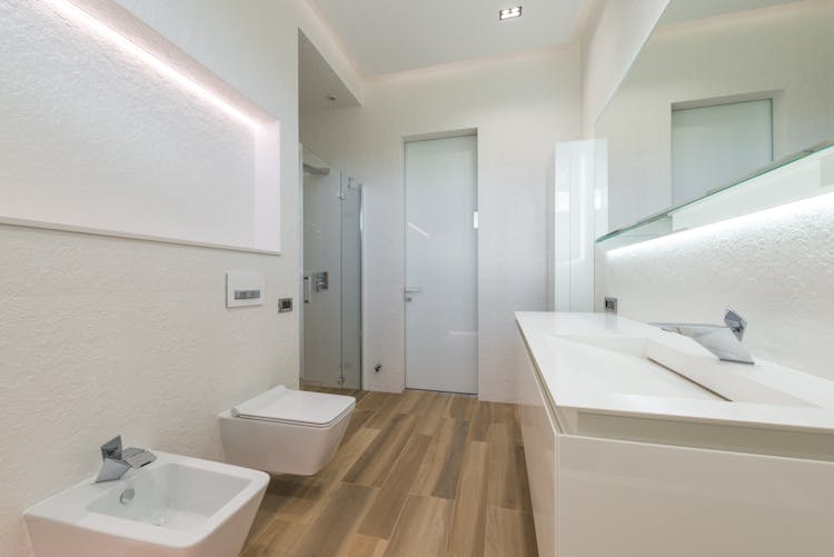 Spacious Bathroom Interior With White Furniture