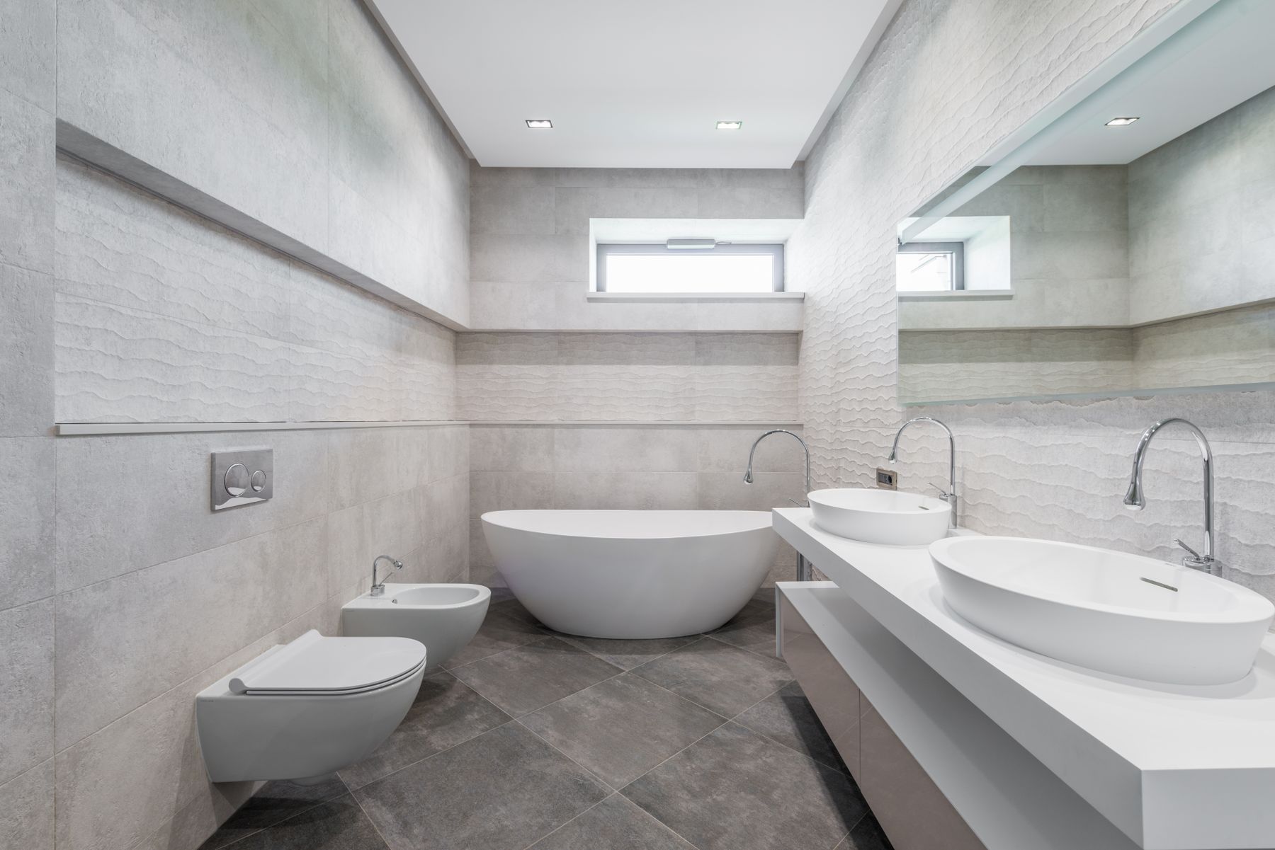 Light luxury bathroom with freestanding bathtub, double washbasin and generous open floor area