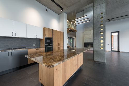 Free Spacious lobby with interior of modern kitchen with multicolored cabinets and wooden table in corner Stock Photo