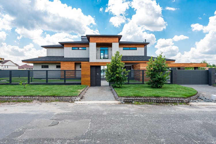 Exterior Of Fenced Modern Villa In Suburb Area