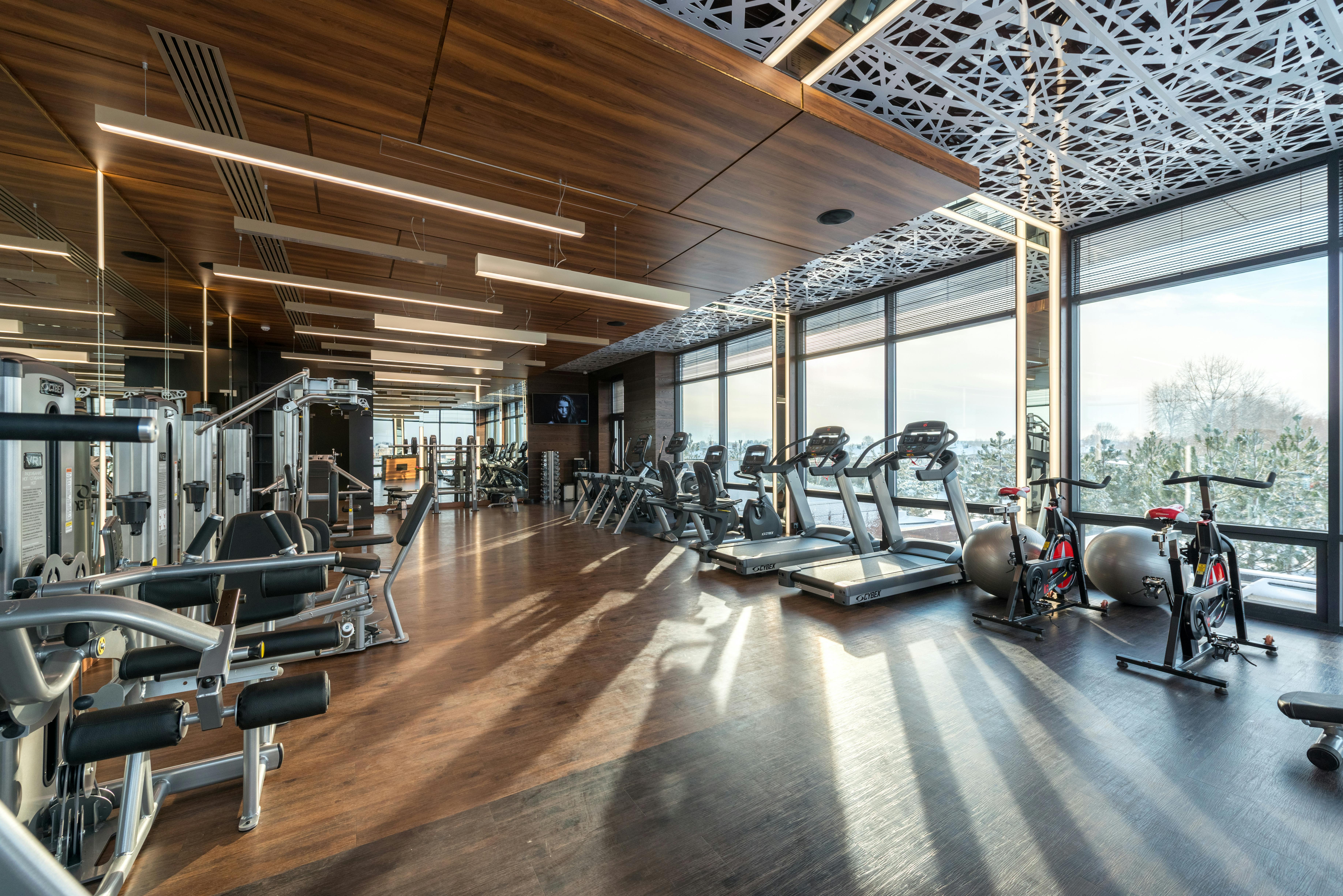 interior of modern fitness club with various machines and equipment