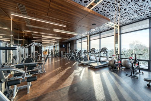 Interior of modern fitness club with various machines and equipment