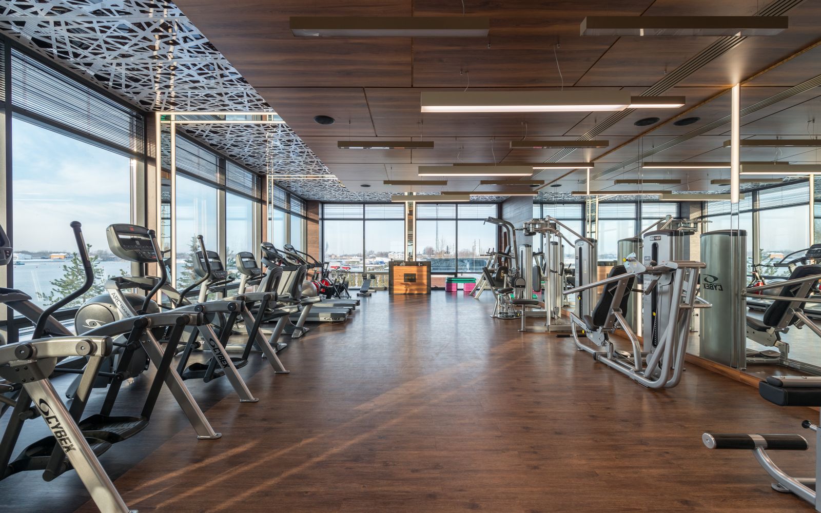 Interior of a modern, spacious fitness club with cardio machines and weights