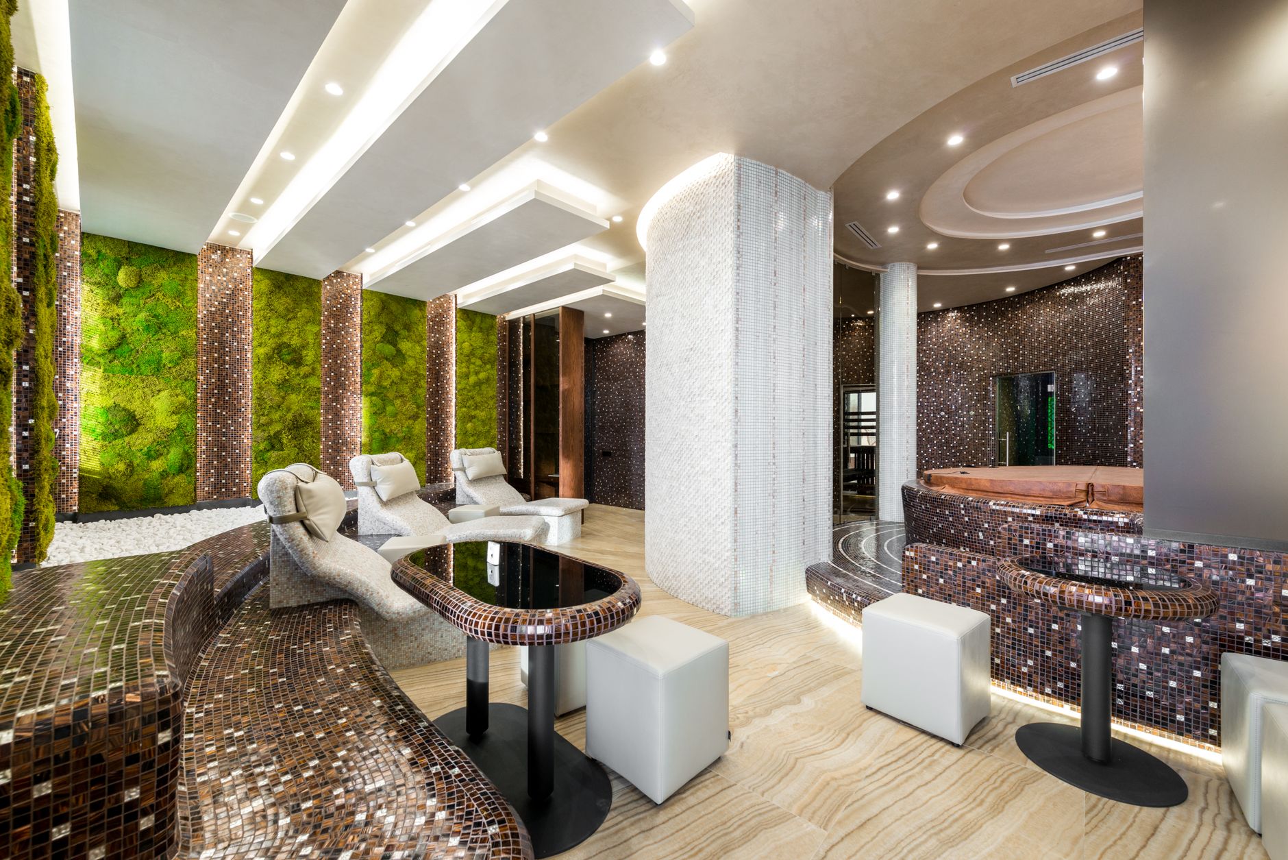 Spacious wellness center with heated loungers and bathtubs