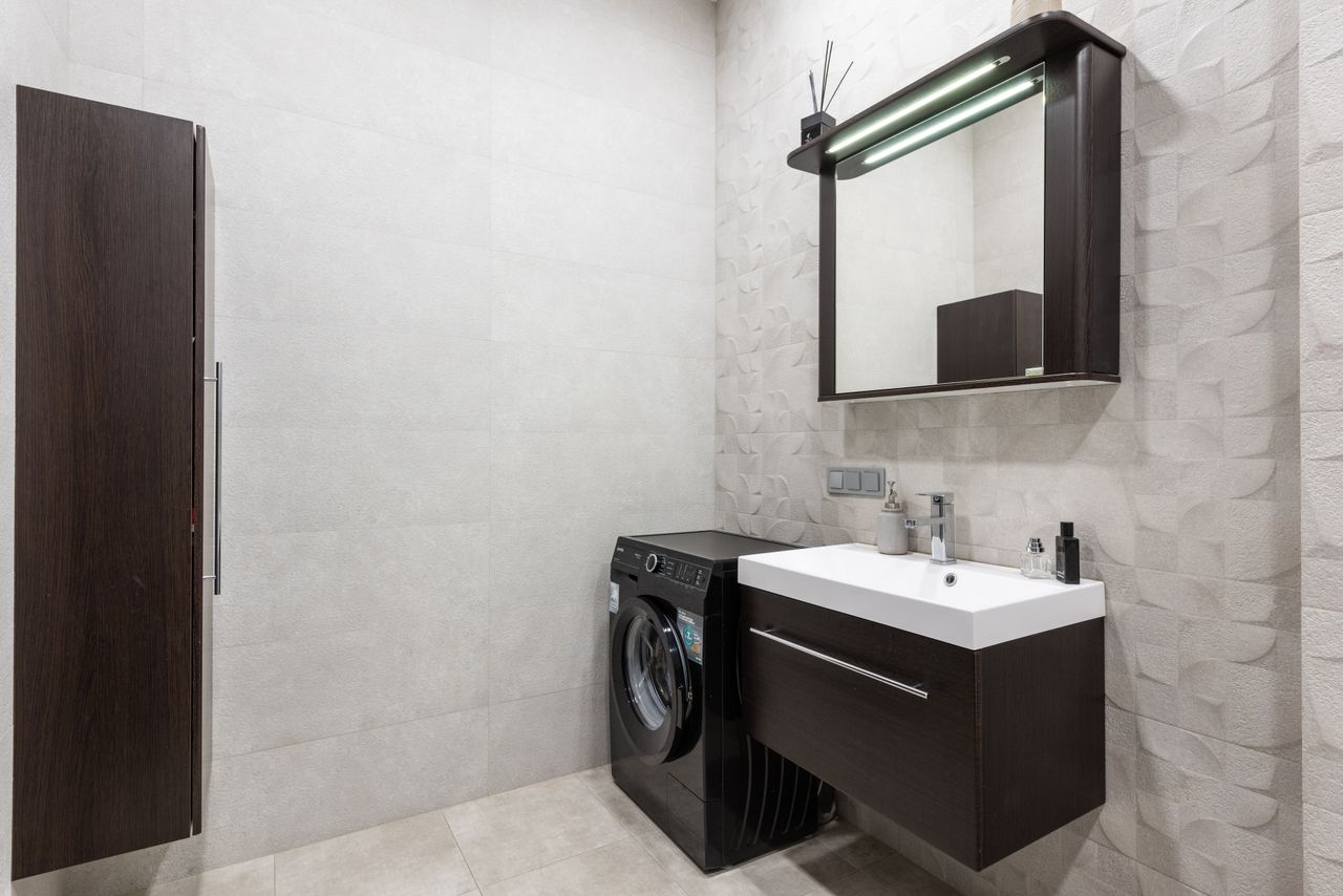 A deep utility sink with cabinetry around it