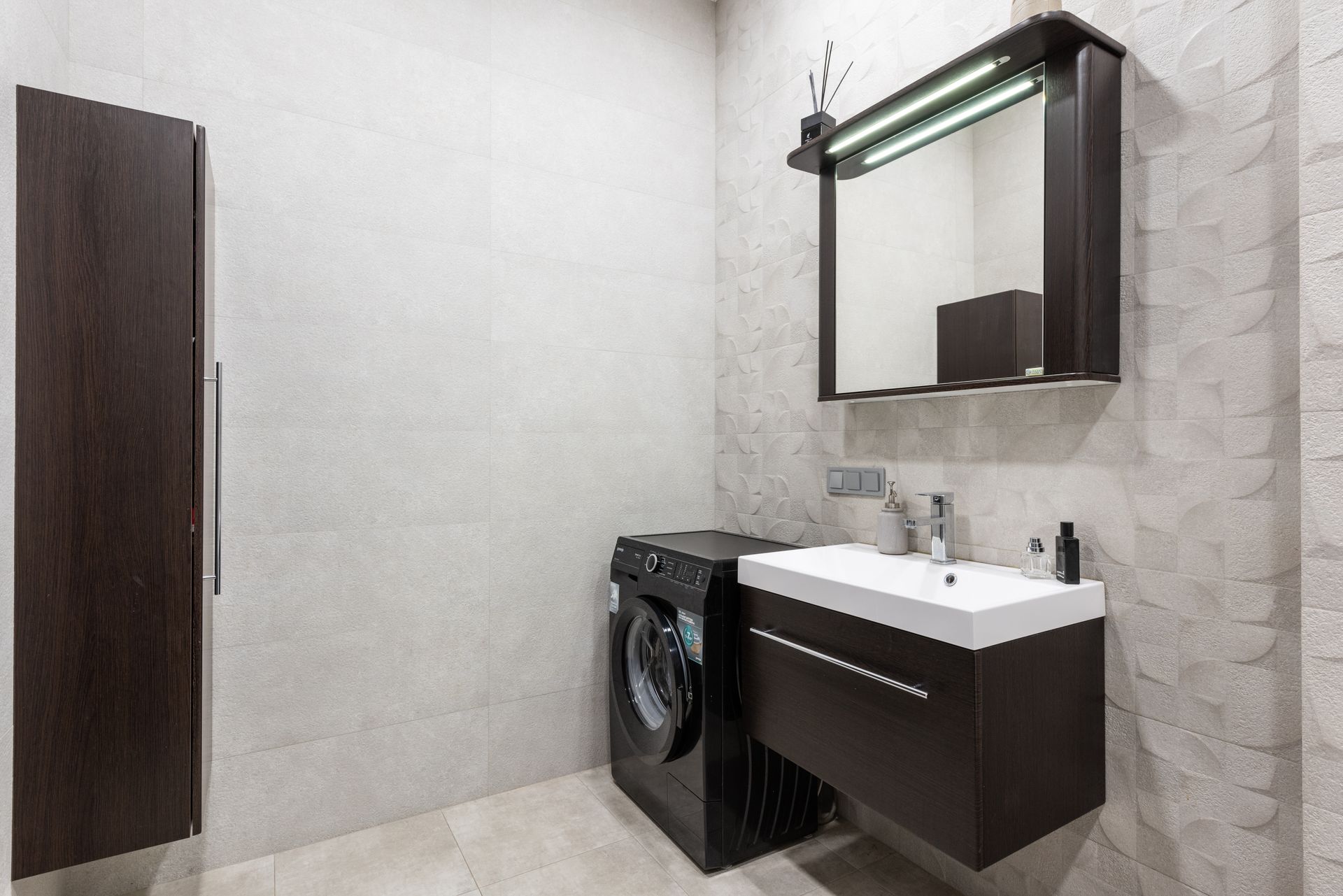 Bathroom with washing machine and sink
