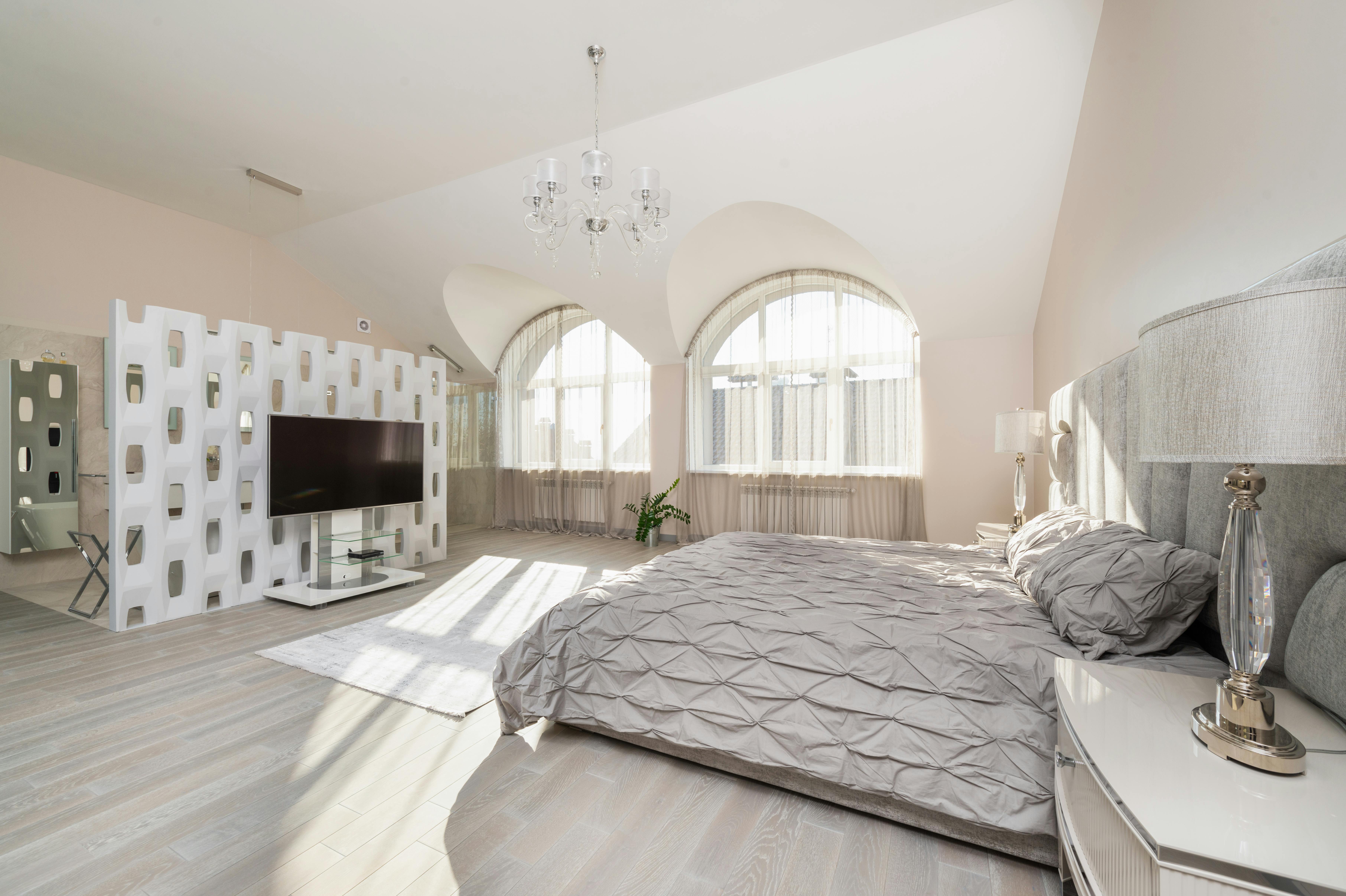 bedroom interior with bed near window and tv