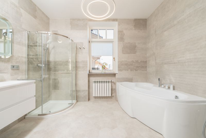 Contemporary bathroom featuring a glass shower cabin and bathtub