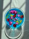 Red and Yellow Flowers on Blue Round Plate