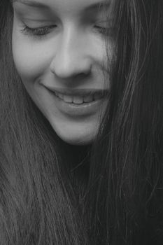 Close-up black and white portrait of a smiling woman, Kyiv.