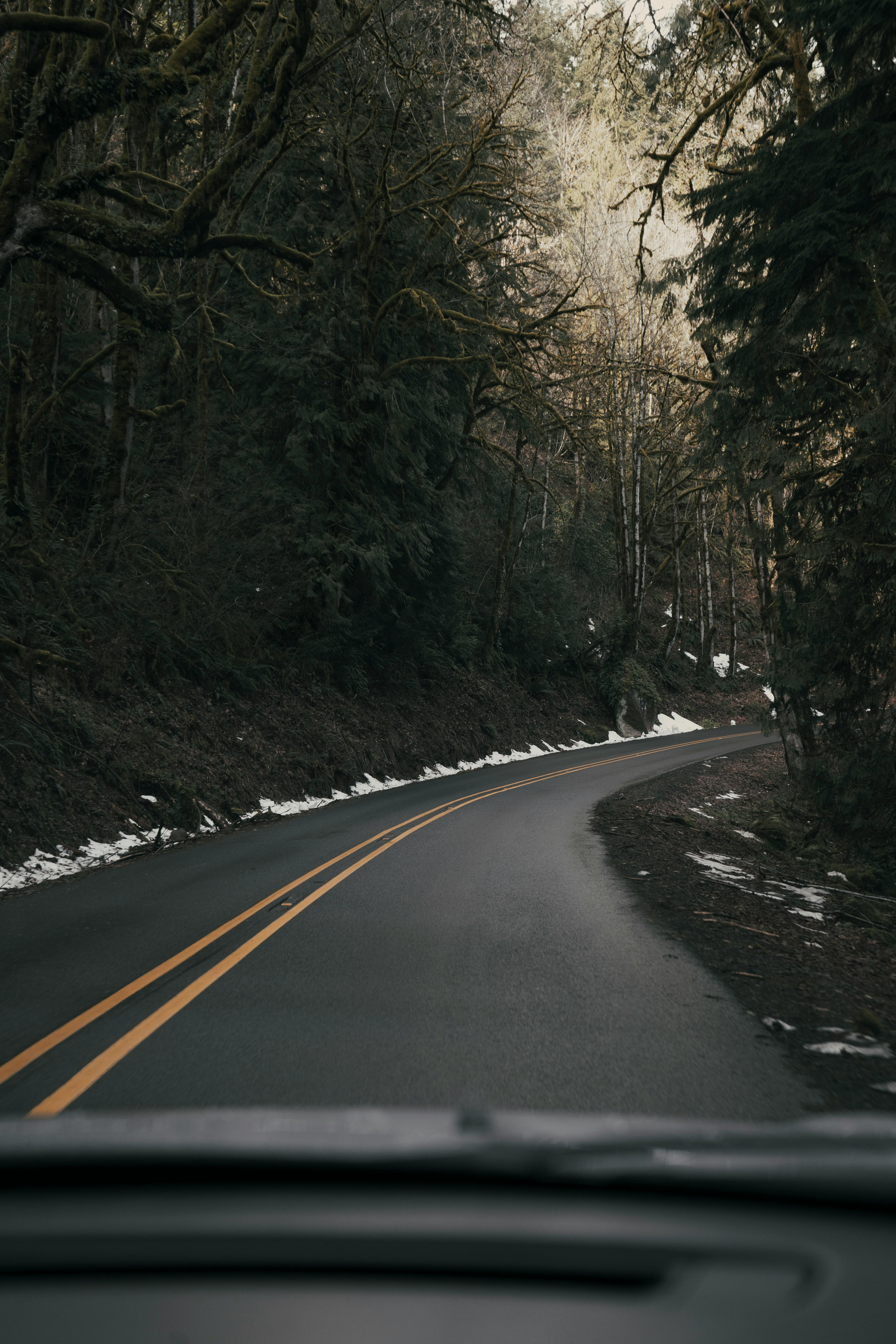 road in the mountains with snow on the side