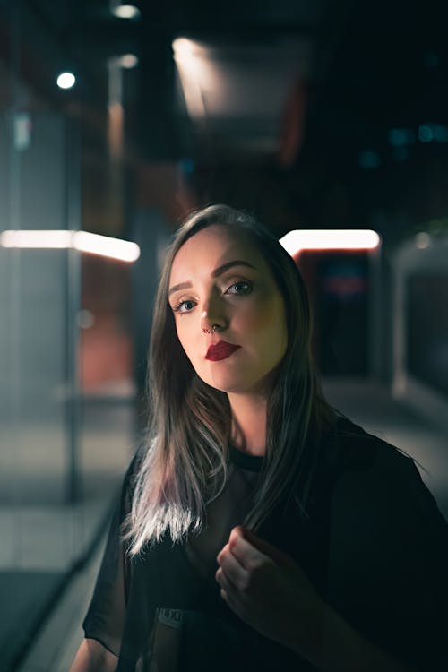 Woman with bright red lips among bright lights