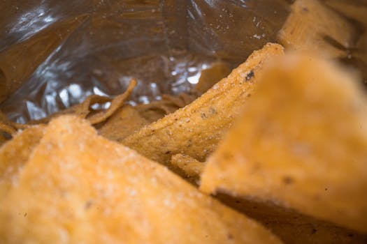 A detailed close-up shot of nachos inside a bag with a textured surface.