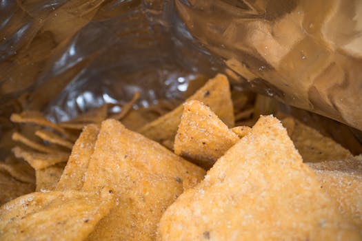 Crispy tortilla chips in a silver foil bag, perfect for snack lovers.
