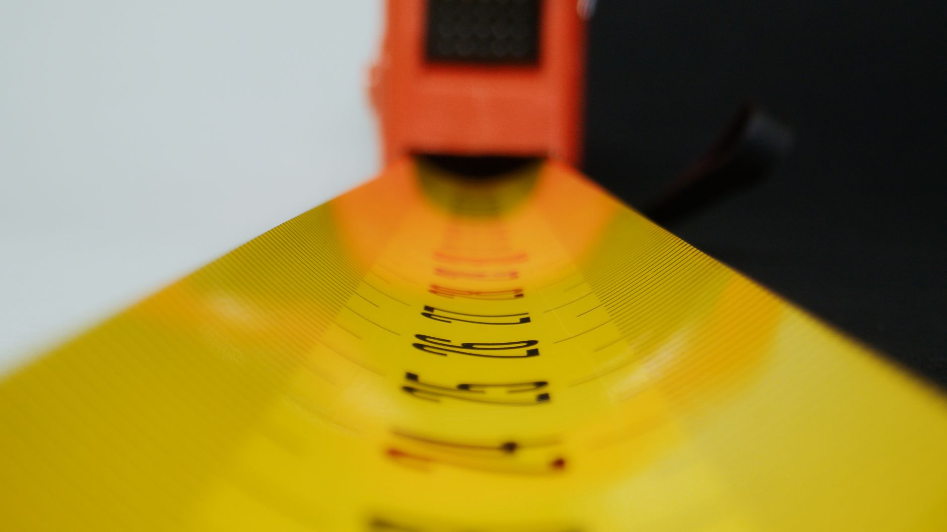 How to Pick the Right Tape at Home Depot for Each Task Detailed view of a yellow tape measure with selective focus on numbers