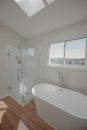 White Ceramic Bathtub Near White Framed Glass Window