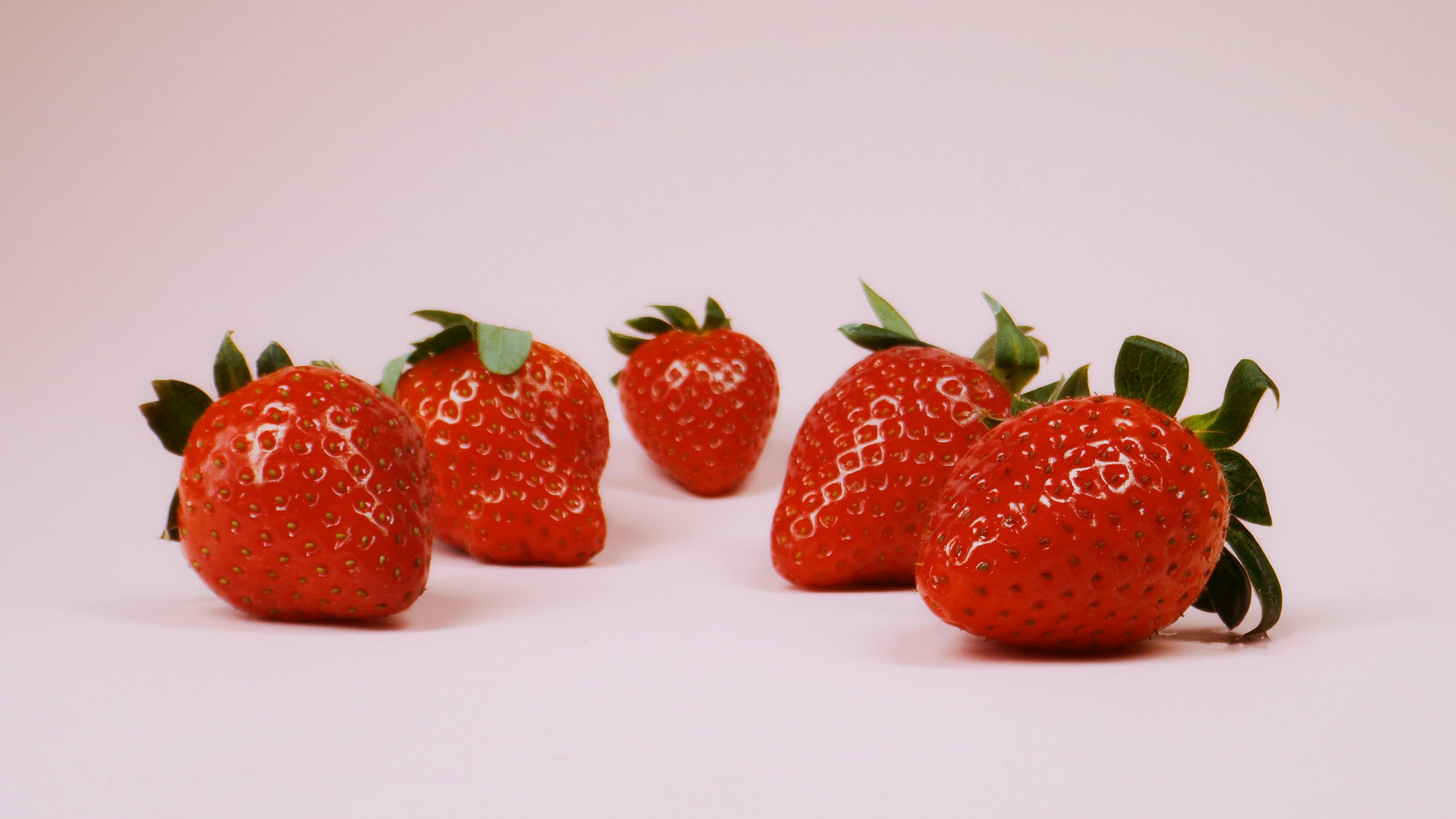 strawberries on pink surface