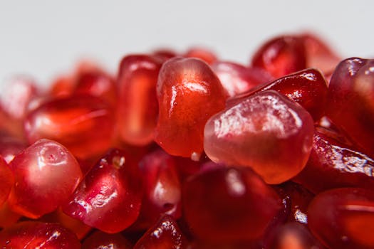 Vibrant close-up image of fresh pomegranate seeds, showcasing their juicy texture.