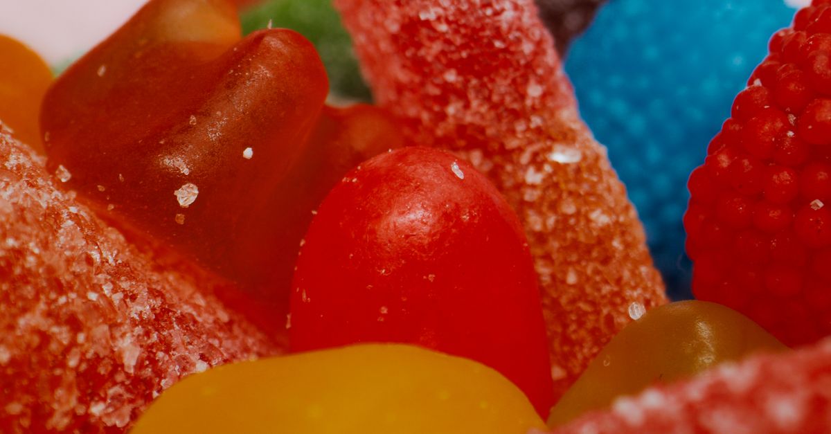 Vibrant assortment of sugary gummy candies up close, showcasing textures and colors.