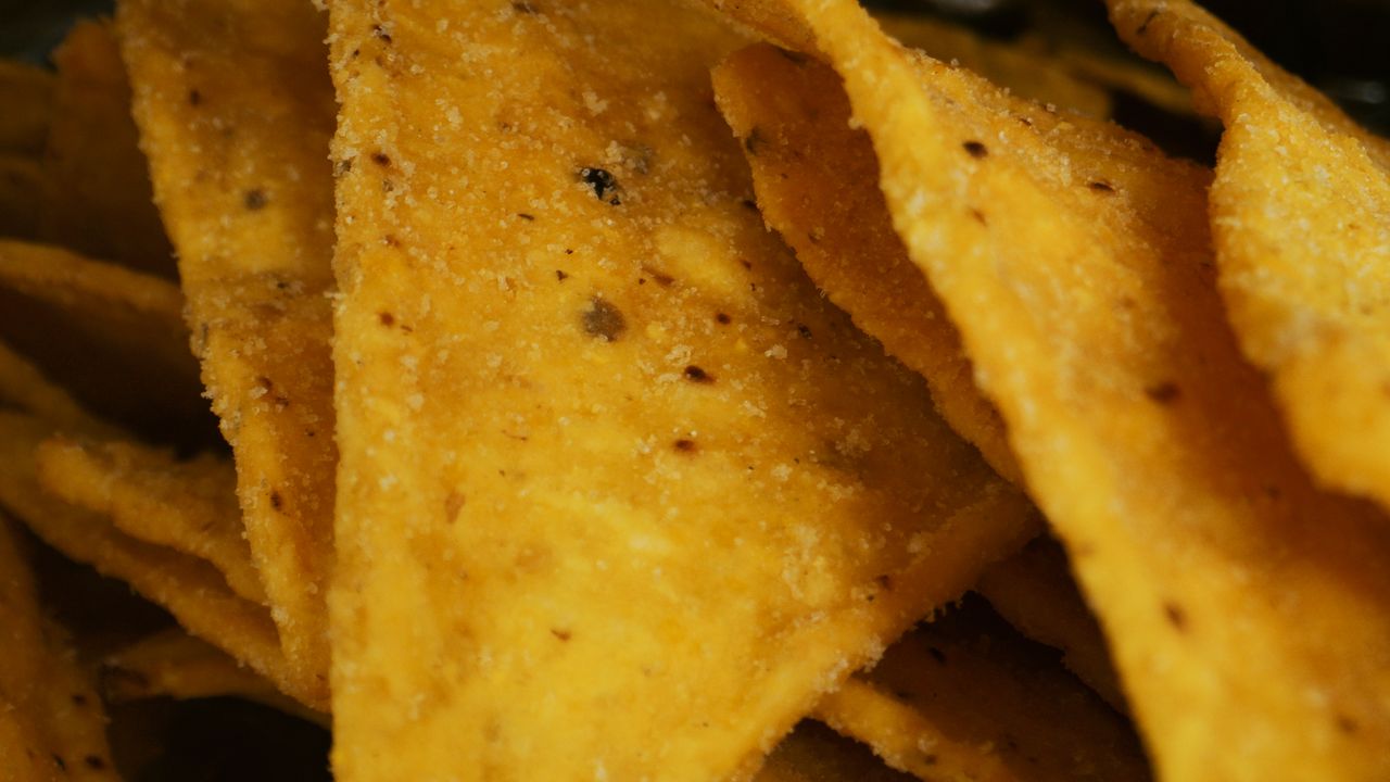 macro shot of crunchy yellow corn chips with seasoning ideal for snack