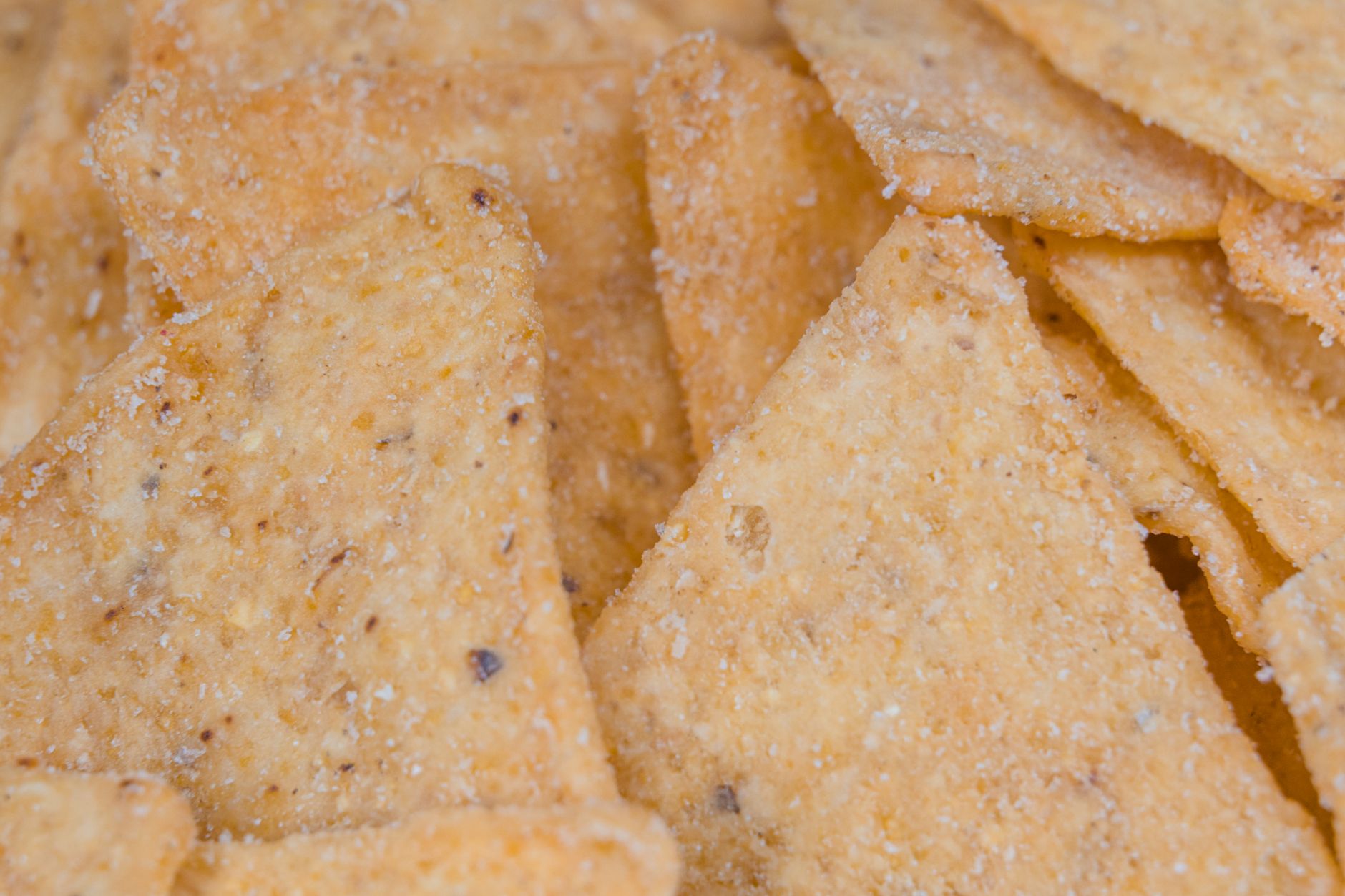 Warm and spiced tortilla chips on a baking sheet