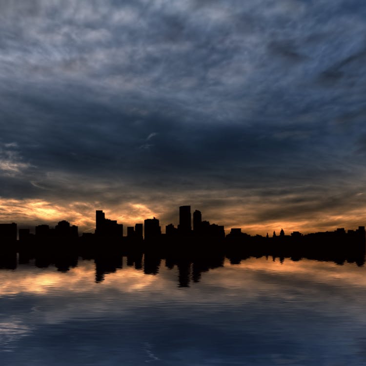 Silhuoette Photography of Black Pedestal Stone on Body of Water