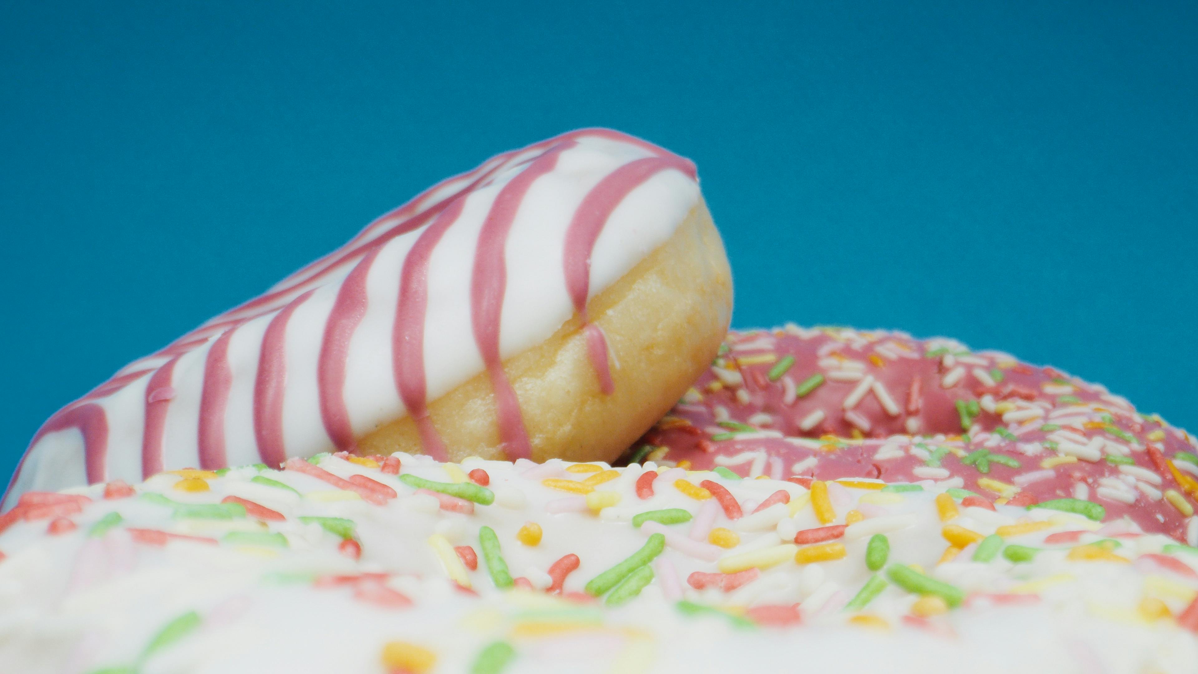 Mini pink glazed doughnuts in paper bag isolated on white Stock Photo by  ©Lena_Zajchikova 319122378