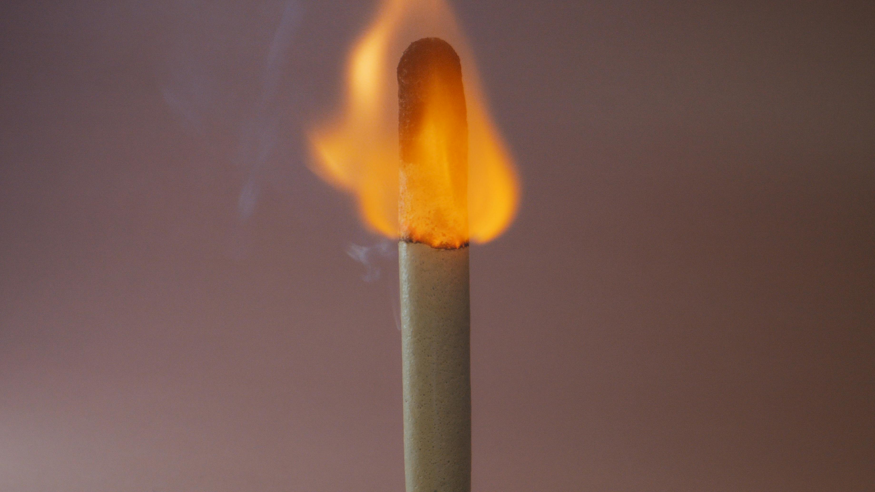 close up photo of a burning match stick