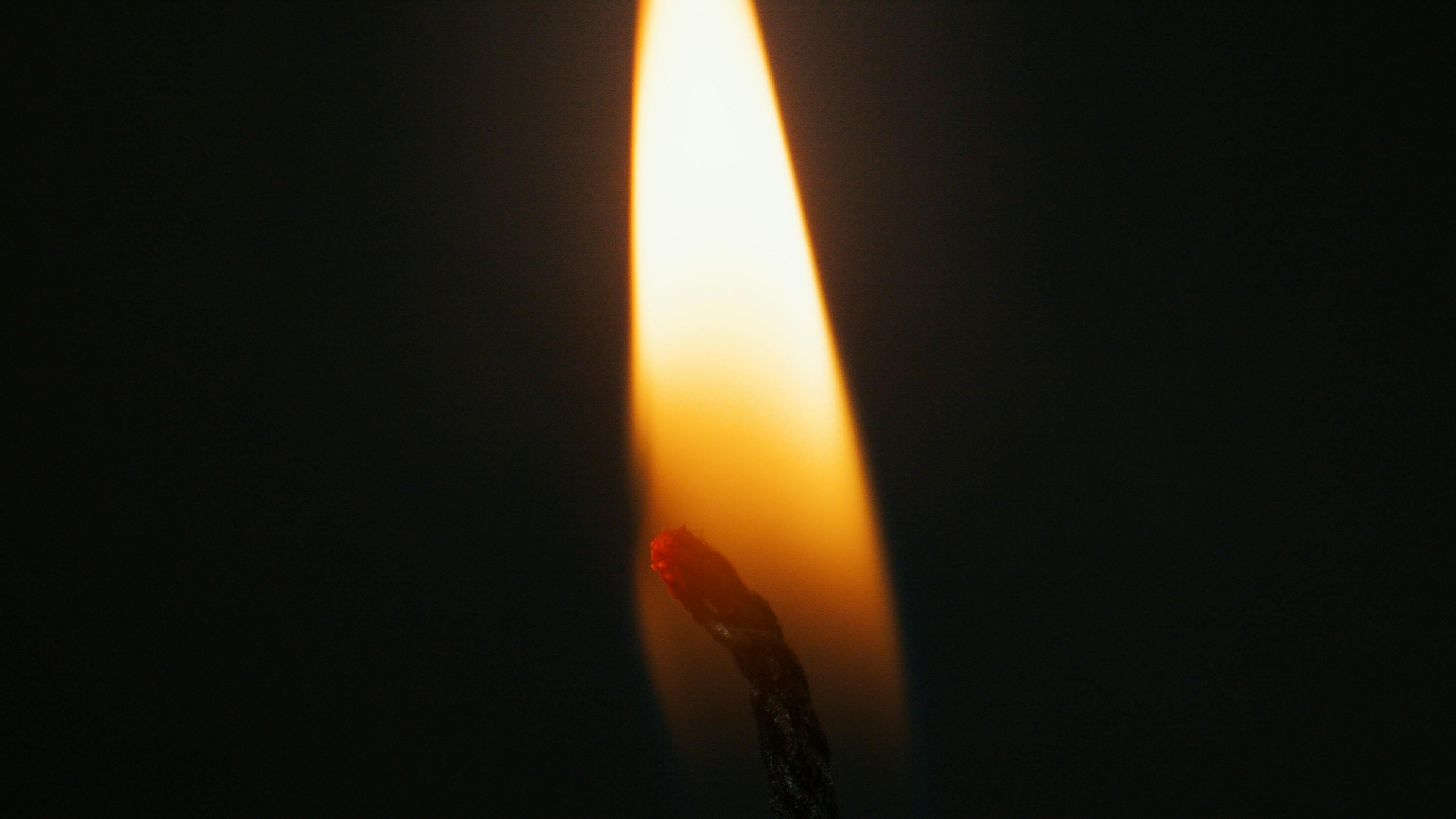 a lighted candle wick in close up shot