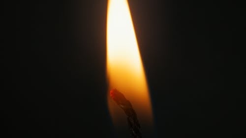 A Lighted Candle Wick in Close-up Shot