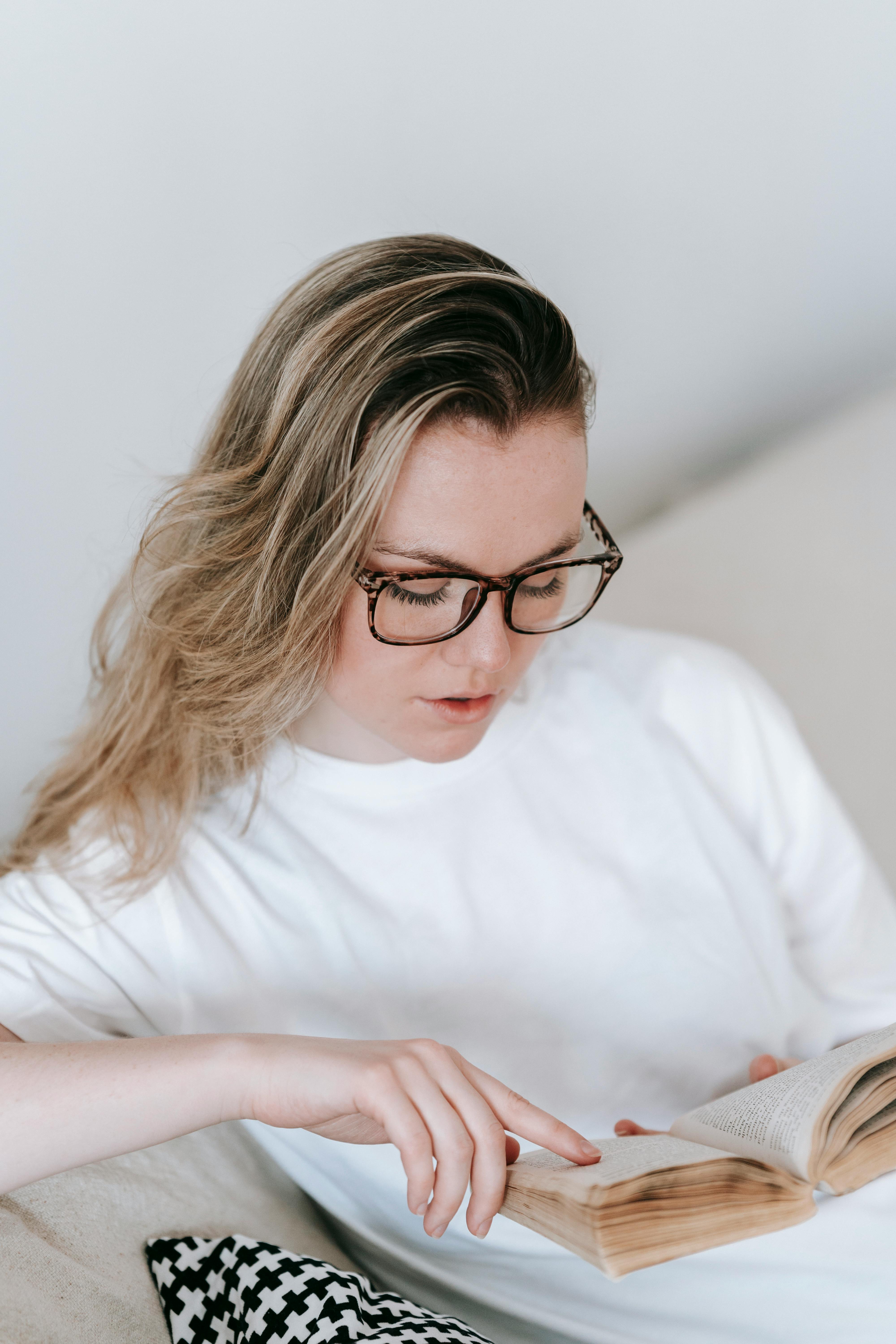 clever woman reading book with interest