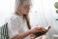 Focused woman flipping page of book