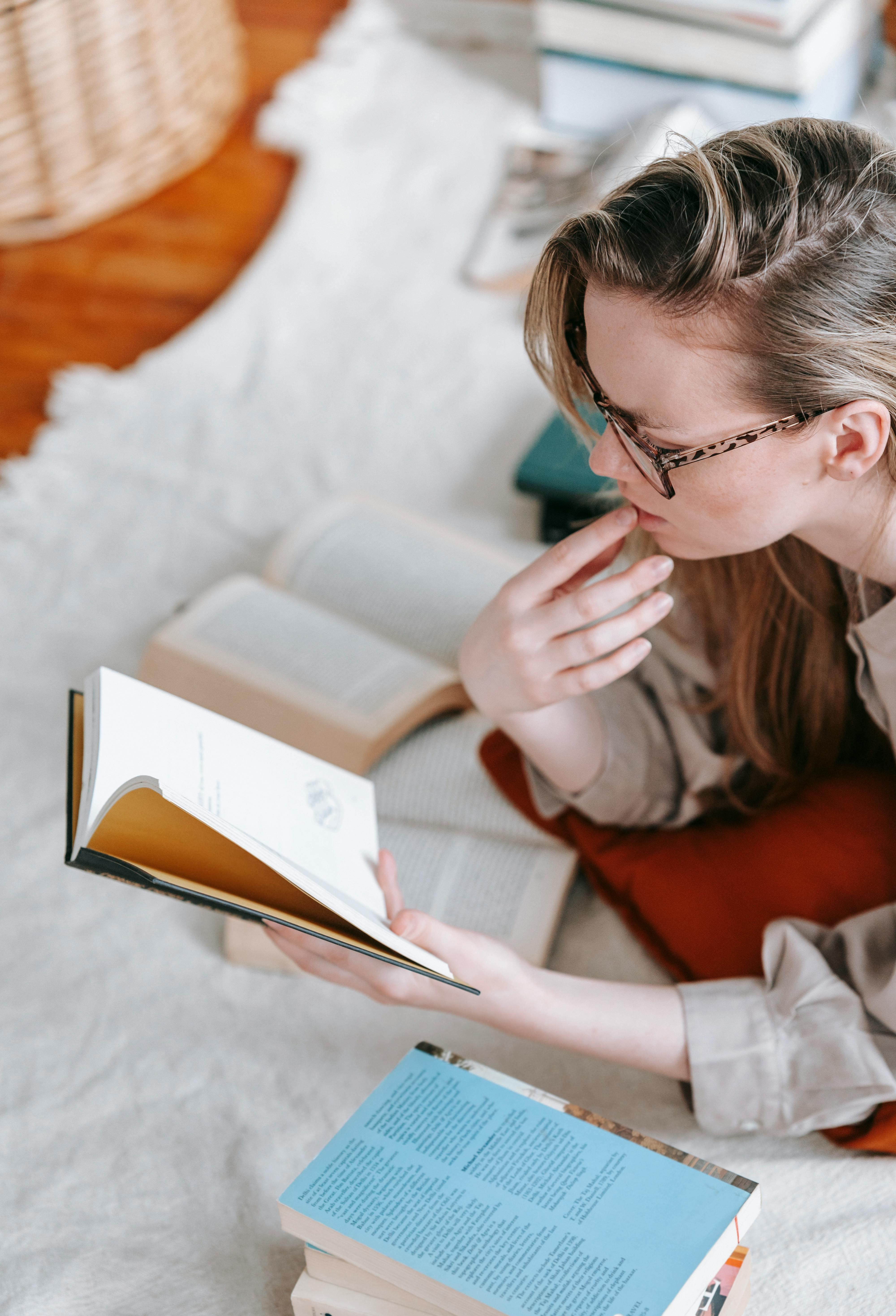 focused woman reading book in room